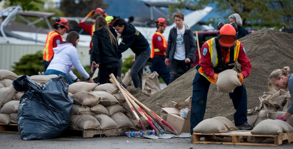 Relief workers prepare sandbags in the Okanagan