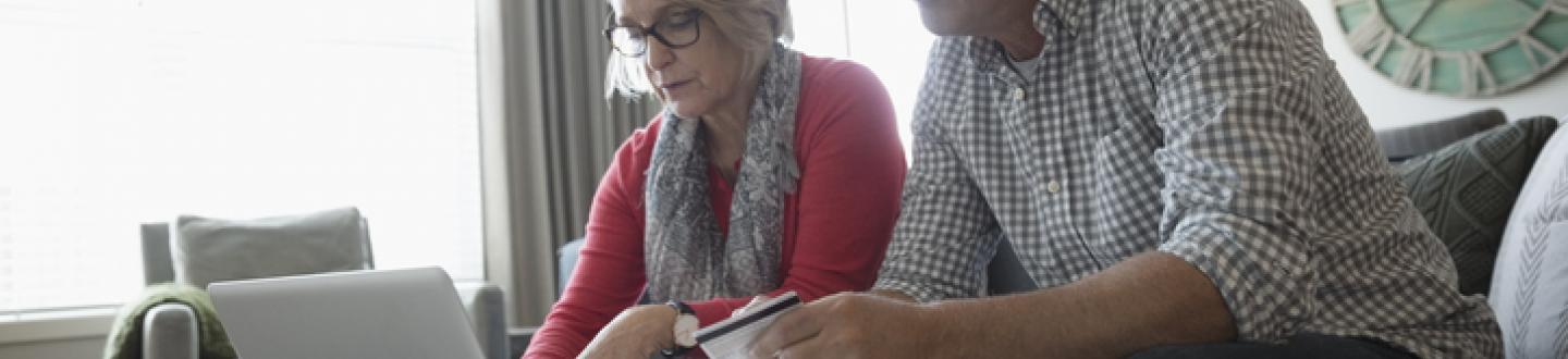 Senior couple looking over laptop