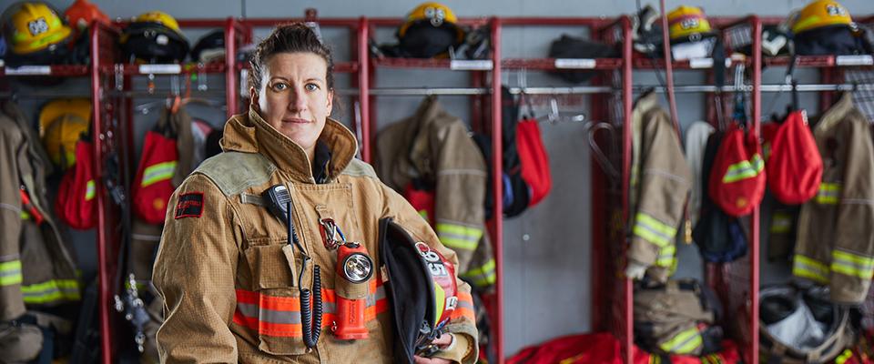 Firefighter in uniform in a fire station. 