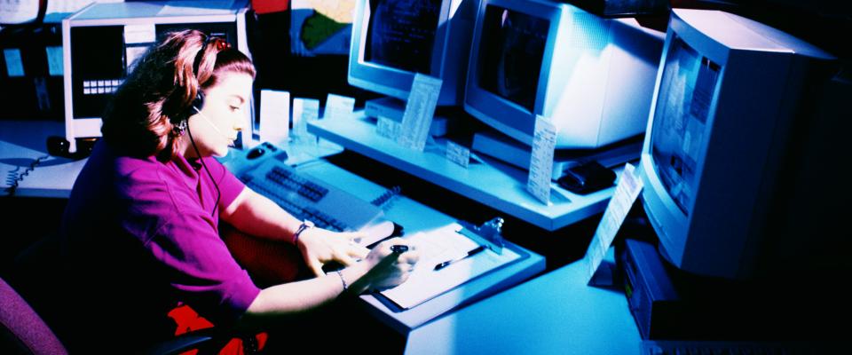 Woman behind computer monitors