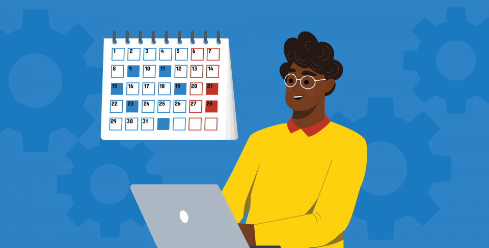 Personne travaillant sur un portable devant un calendrier. 
